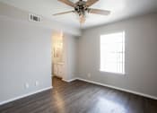 Thumbnail 20 of 34 - A room with a ceiling fan and a window.