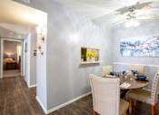 Thumbnail 6 of 34 - A dining room with a table set for four.