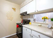 Thumbnail 7 of 34 - A kitchen with a beige wall and a honeycomb decoration.