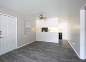 Thumbnail 14 of 34 - A room with a white door, a ceiling fan, and a window with blinds.