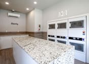 Thumbnail 34 of 64 - A laundry room with a washer and dryer.
