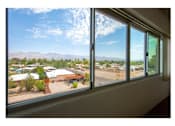 Thumbnail 26 of 36 - A view of a landscape from a window with a building in the distance.