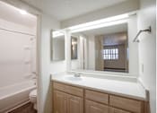 Thumbnail 63 of 70 - A bathroom with a white sink and a white tub.