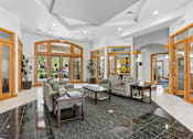 Thumbnail 15 of 27 - A spacious lobby with a coffee table and couches.
