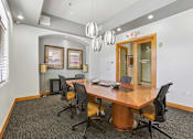 Thumbnail 13 of 27 - A conference room with a large table and chairs.