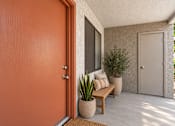 Thumbnail 11 of 45 - A brown door is on the left of a patio with a bench and potted plants.