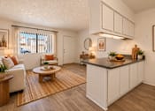 Thumbnail 7 of 45 - A kitchen with white cabinets and a wooden island.