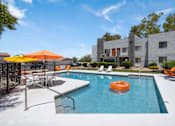 Thumbnail 1 of 45 - A pool with a sun lounger and umbrella.