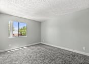 Thumbnail 14 of 42 - A room with a window and a carpeted floor.