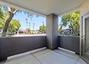 Thumbnail 23 of 25 - A patio with a view of a tree and houses.