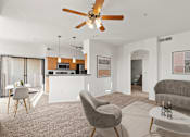 Thumbnail 10 of 25 - A living room with a grey chair and a white coffee table.