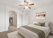 Thumbnail 7 of 25 - A bedroom with a large bed and a ceiling fan.