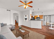 Thumbnail 9 of 25 - A living room with a grey couch and a wooden coffee table.