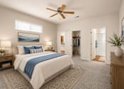 Thumbnail 6 of 26 - A bedroom with a large bed and a ceiling fan.