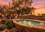 Thumbnail 3 of 27 - A pool surrounded by a stone wall and plants.