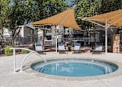 Thumbnail 7 of 23 - A small pool surrounded by chairs and umbrellas.
