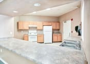 Thumbnail 8 of 10 - Community Center Kitchen at Mira Vista Apartments in Las Cruces