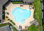 Thumbnail 59 of 64 - A small swimming pool surrounded by a fence and a small garden.