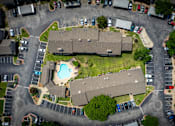 Thumbnail 57 of 64 - A bird's eye view of a residential area with houses, cars, and a swimming pool.