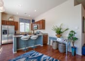 Thumbnail 4 of 19 - Kitchen Breakfast Bar and Living Room at Avilla Tanque Verde