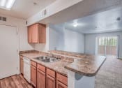Thumbnail 2 of 10 - Kitchen and living Room at Los Altos Apartments in Las Cruces