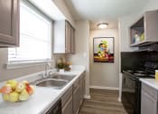 Thumbnail 21 of 64 - Kitchen with Dual Sink at The Villas at Quail Creek Apartment Homes in Austin Texas
