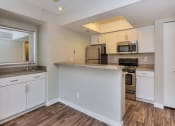 Thumbnail 8 of 19 - Kitchen with Wet Bar at Olive East Apartments