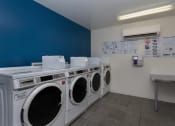Thumbnail 22 of 60 - Laundry room at The Regency Apartments in Tempe AZ March 2020