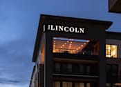 Thumbnail 26 of 28 - The Lincoln building is lit up at dusk.