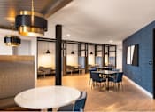 Thumbnail 16 of 28 - A modern dining room with a white table and blue patterned wall.