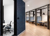 Thumbnail 18 of 28 - A room with a blue patterned wall and a black chair.