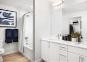 Thumbnail 24 of 28 - A bathroom with a white toilet, a white sink, and a white bathtub.