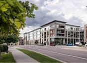 Thumbnail 28 of 28 - A street view of a residential area with apartment buildings.