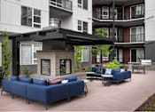 Thumbnail 8 of 28 - A blue couch is in the middle of a courtyard.