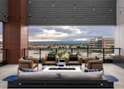 Thumbnail 2 of 28 - A modern outdoor seating area with a view of the cityscape.