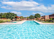Thumbnail 16 of 45 - A large swimming pool in a sunny outdoor setting.