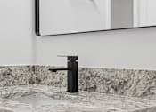 Thumbnail 8 of 25 - A black faucet with a sink and a mirror above it.