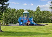 Thumbnail 18 of 25 - A playground with a blue slide and a green roof.