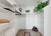 Thumbnail 16 of 16 - A small room with a hanging shelf and a rug on the floor.