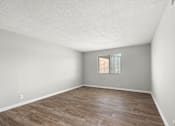 Thumbnail 10 of 26 - A room with wooden flooring and a window with blinds.