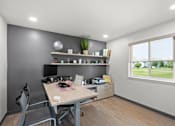 Thumbnail 15 of 26 - A room with a desk, chair, and shelves with various items.