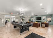 Thumbnail 13 of 17 - A pool table is in the middle of a room with a chandelier hanging from the ceiling.