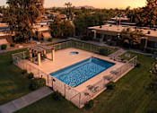 Thumbnail 3 of 17 - A swimming pool surrounded by a fence in a backyard.