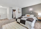 Thumbnail 21 of 37 - a bedroom with a bed and a rug at The Meriden, Meriden, CT 06450