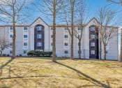 Thumbnail 14 of 37 - a white apartment building with trees in front of it at The Meriden, Connecticut, 06450