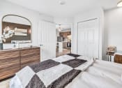 Thumbnail 8 of 37 - a bedroom with a bed and a kitchen in the background at The Meriden, Meriden, 06450 
