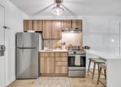 Thumbnail 23 of 37 - a kitchen with stainless steel appliances and wooden cabinets at The Meriden, Meriden, 06450