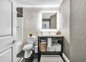 Thumbnail 9 of 37 - a bathroom with a toilet sink and a mirror at The Meriden, Meriden, CT 06450