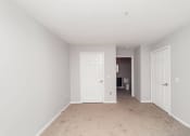 Thumbnail 7 of 22 - a bedroom with two doors and a carpeted floor at Ardenwood Apartments, North Haven, Connecticut