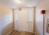 Thumbnail 20 of 24 - an empty room with a white door and a refrigerator at BAY SHORE APARTMENTS, EAST HAVEN, 06512